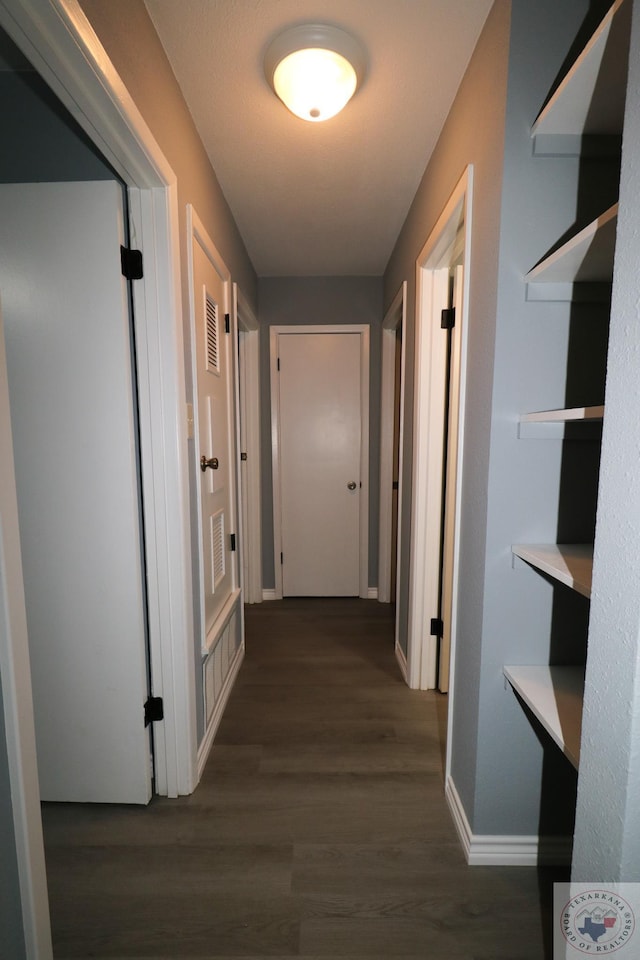 hallway featuring dark wood-type flooring