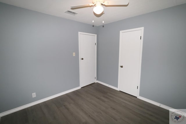 spare room featuring ceiling fan and dark hardwood / wood-style floors