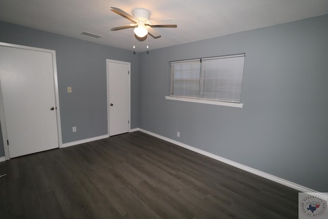 unfurnished room with ceiling fan and dark hardwood / wood-style flooring