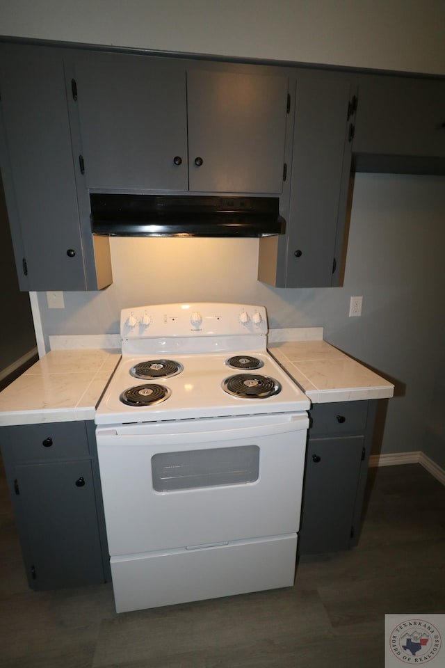 kitchen with dark wood-type flooring, gray cabinetry, and white range with electric cooktop