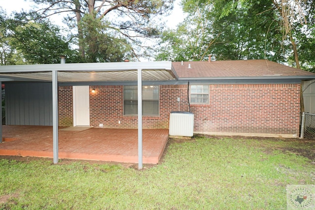 rear view of property featuring a yard