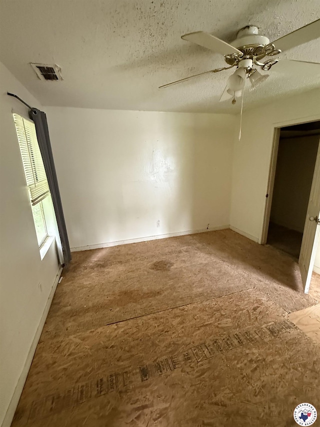5853 Wallace Rd, Texarkana, AR 71854 - unfurnished room featuring a ceiling fan, baseboards, and a textured ceiling