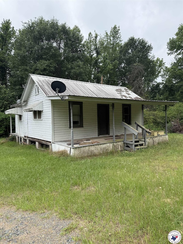 5853 Wallace Rd, Texarkana, AR 71854 - view of front of home featuring covered porch, metal roof, and view of wooded area