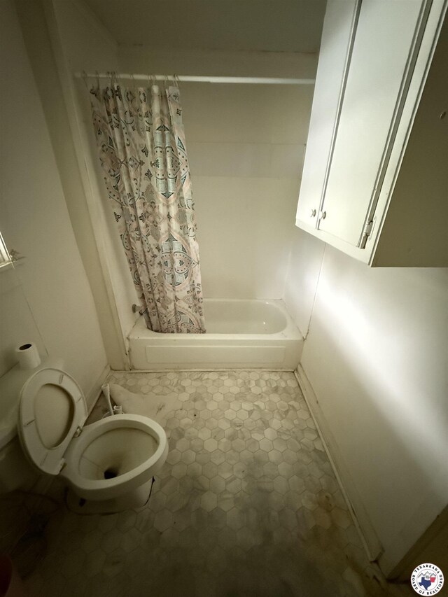 5853 Wallace Rd, Texarkana, AR 71854 - bathroom featuring toilet, shower / bath combo with shower curtain, and baseboards