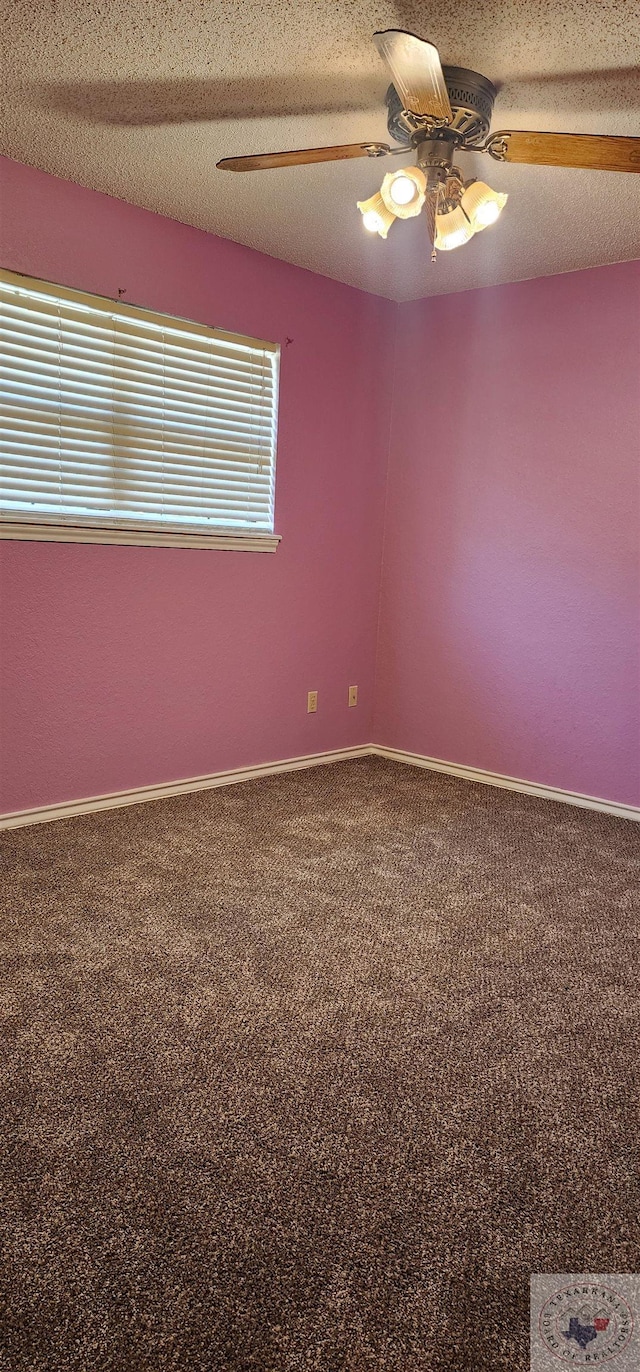 carpeted spare room with ceiling fan and a textured ceiling