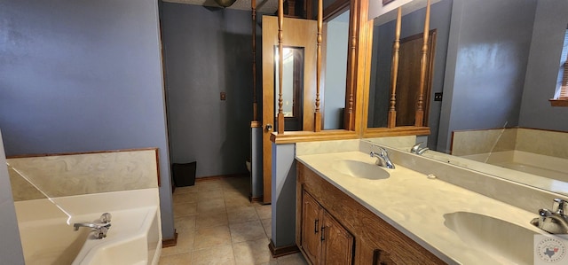 bathroom featuring tile patterned floors, a tub to relax in, and vanity