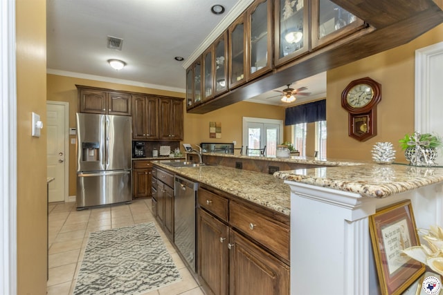 7 Brittan Pl, Texarkana, TX 75503 - kitchen with appliances with stainless steel finishes, light tile patterned floors, crown molding, light stone countertops, and ceiling fan