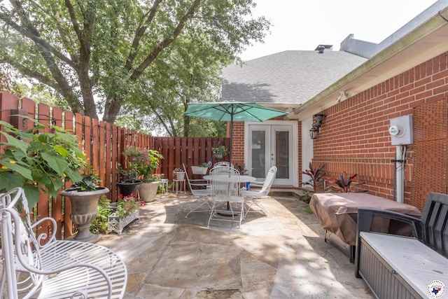 7 Brittan Pl, Texarkana, TX 75503 - fenced backyard featuring french doors, outdoor dining space, and a patio