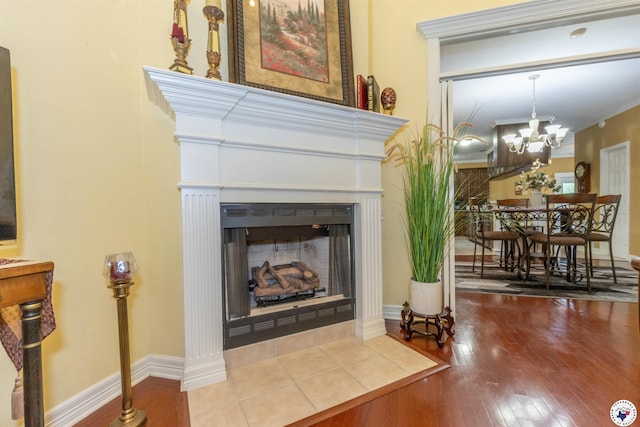 7 Brittan Pl, Texarkana, TX 75503 - detailed view of a fireplace with flush hearth, wood finished floors, a chandelier, and baseboards