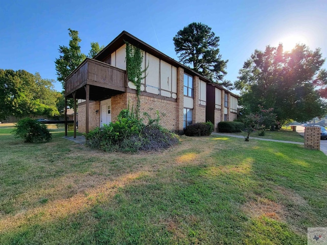 view of home's exterior with a deck and a yard