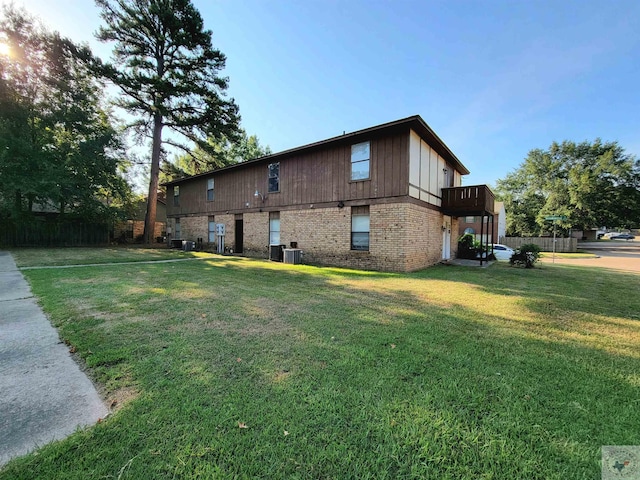 exterior space featuring central AC and a yard