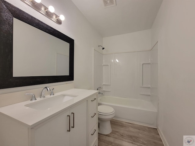 full bathroom featuring hardwood / wood-style flooring, toilet, vanity, and shower / bathing tub combination