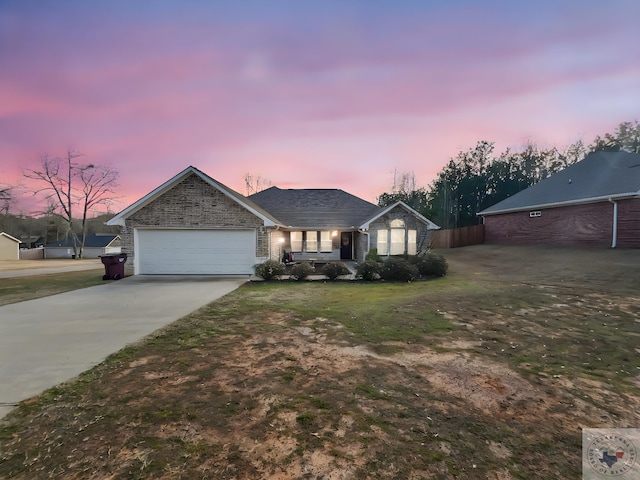 ranch-style house with driveway, an attached garage, and brick siding