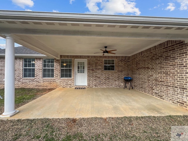 view of patio with area for grilling and a ceiling fan