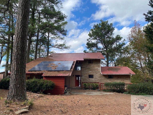 view of front of home featuring solar panels