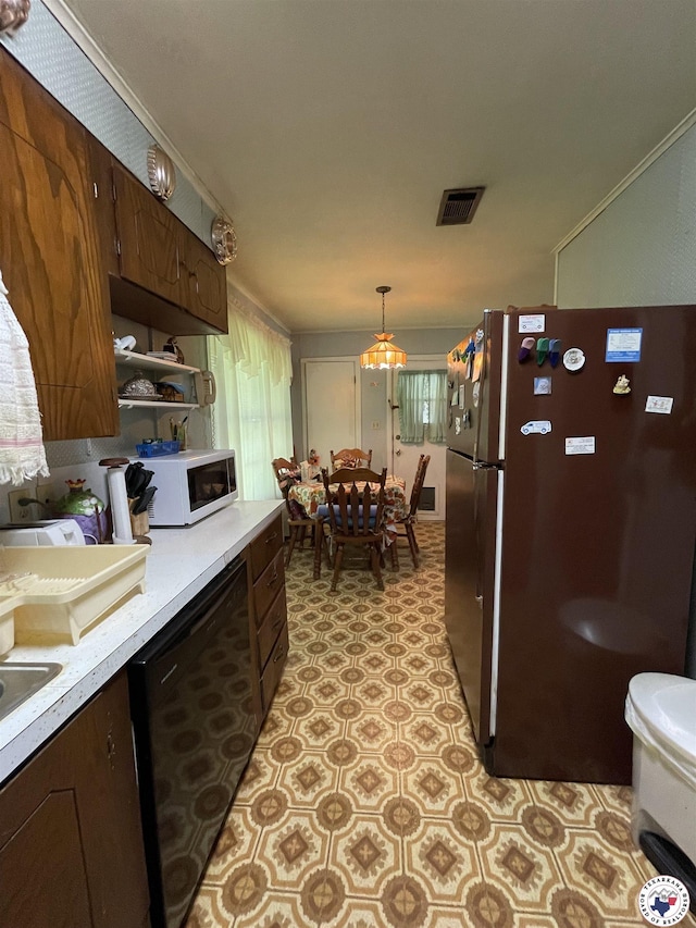 530 Bentley Dr, Nash, TX 75569 - kitchen with freestanding refrigerator, white microwave, black dishwasher, light countertops, and light flooring