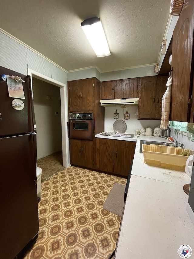 530 Bentley Dr, Nash, TX 75569 - kitchen featuring freestanding refrigerator, oven, light countertops, crown molding, and under cabinet range hood