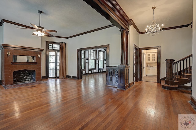 living area with dark wood-type flooring, a fireplace with flush hearth, a ceiling fan, baseboards, and stairs