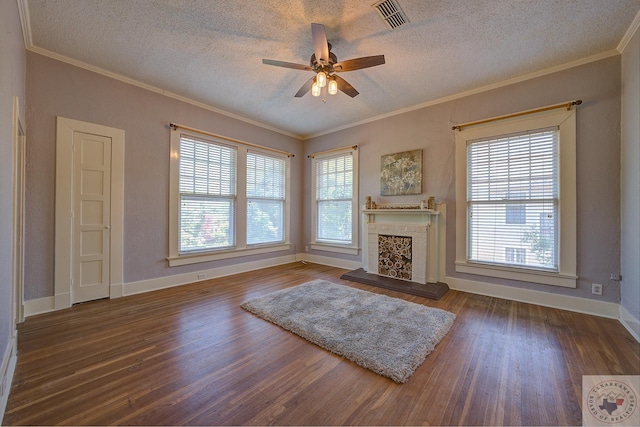 unfurnished living room with dark wood-style floors, a fireplace, crown molding, visible vents, and a textured ceiling