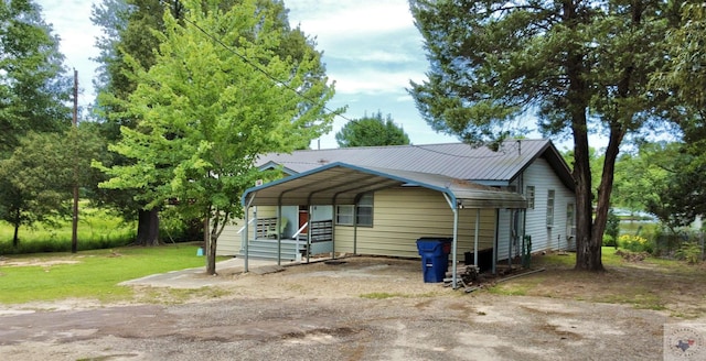 view of front facade with a front yard and a carport