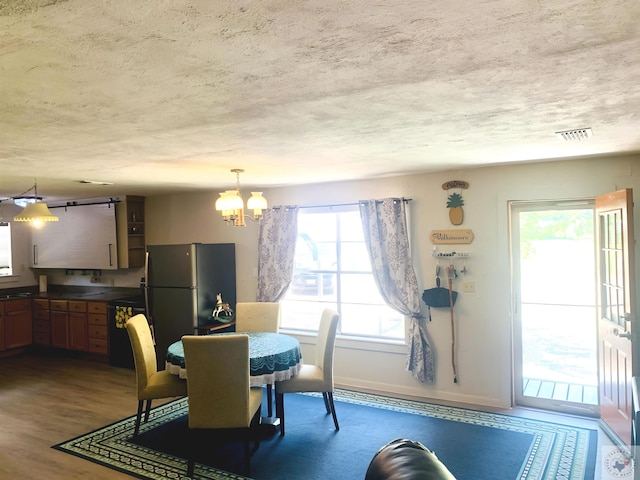 dining area featuring dark hardwood / wood-style floors and a notable chandelier