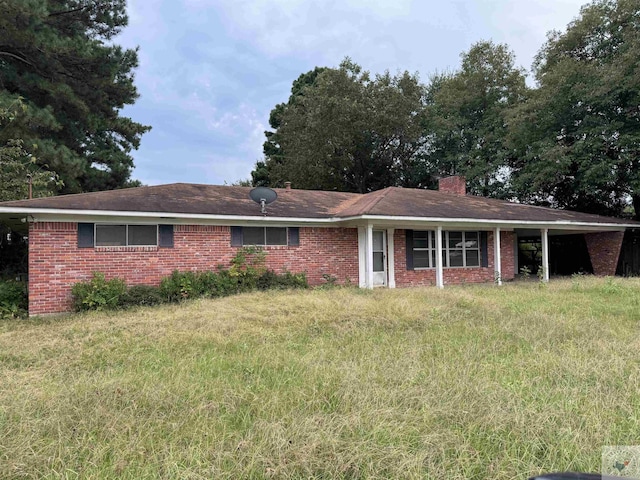 ranch-style house with a chimney and brick siding