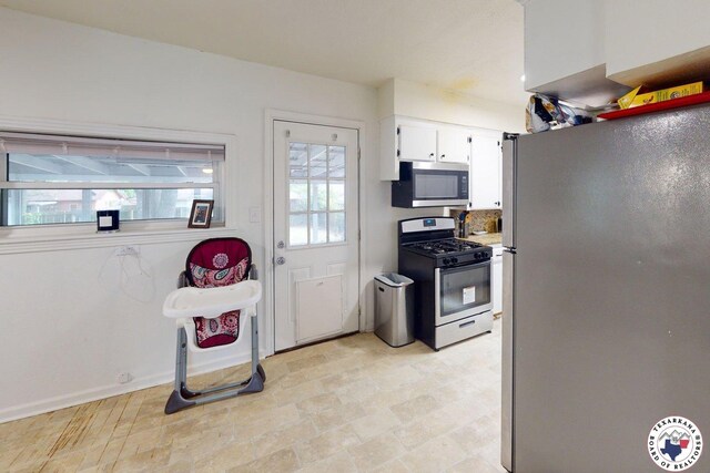 1205 W 40th St, Texarkana, TX 75501 - kitchen featuring stainless steel appliances, white cabinetry, and baseboards
