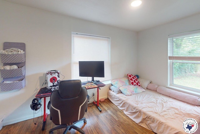 1205 W 40th St, Texarkana, TX 75501 - bedroom featuring wood finished floors, a desk, and baseboards