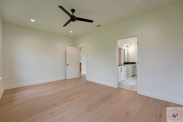 unfurnished bedroom with ceiling fan, light hardwood / wood-style flooring, and ensuite bath