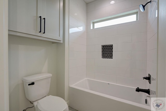 bathroom featuring toilet and tiled shower / bath combo