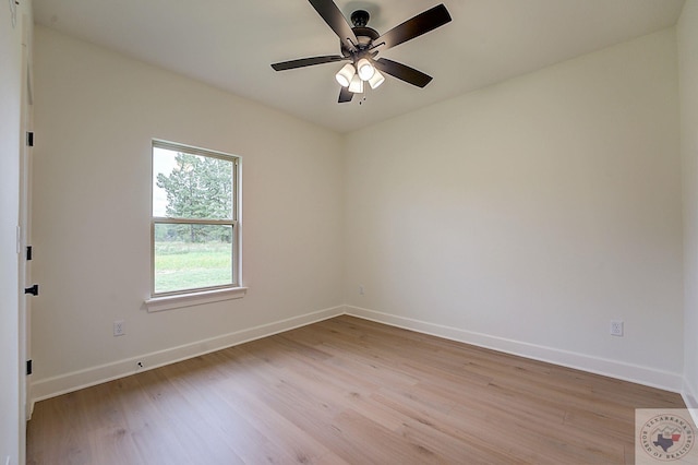 empty room with ceiling fan and light hardwood / wood-style flooring