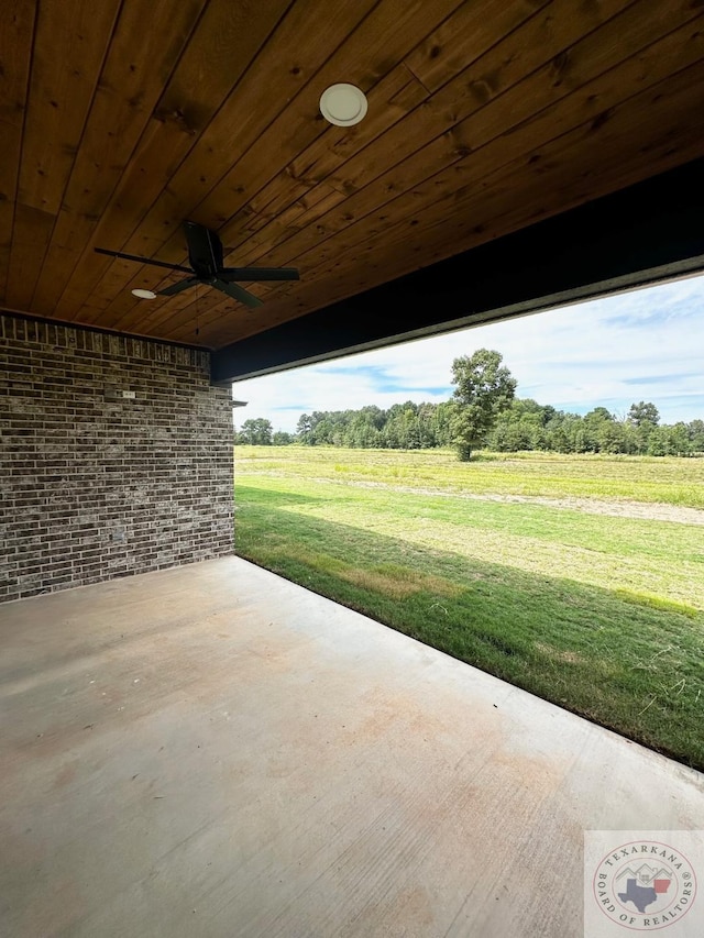 view of patio / terrace featuring ceiling fan and a rural view