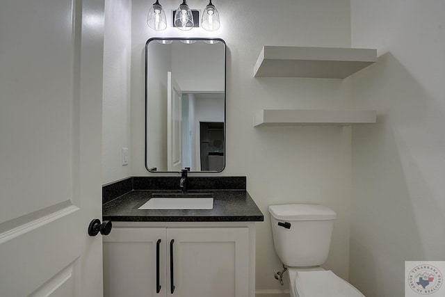 bathroom featuring toilet and vanity