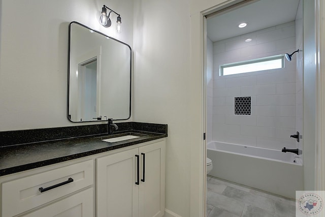 full bathroom featuring toilet, vanity, and tiled shower / bath combo