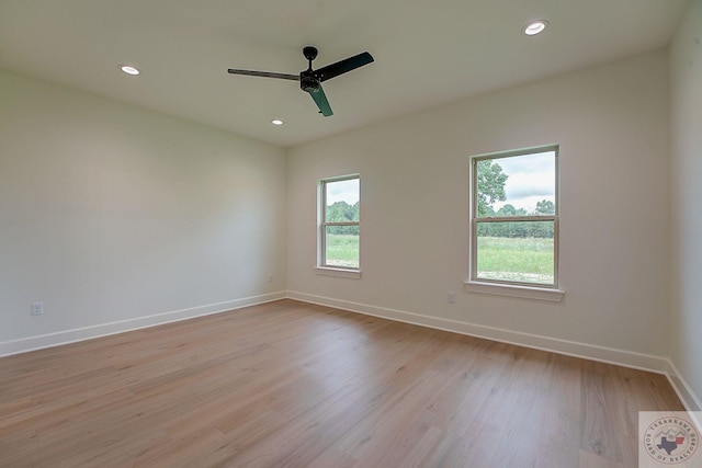 empty room with light wood-type flooring and ceiling fan