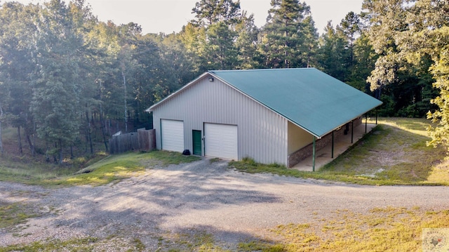 view of outbuilding with a carport and a garage