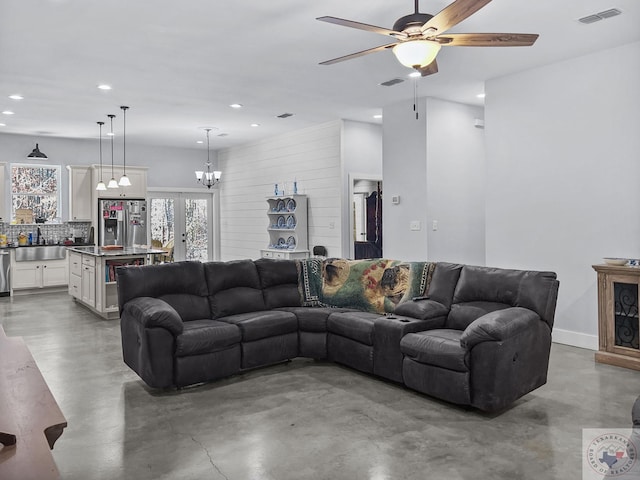 living room with sink, french doors, concrete floors, and ceiling fan