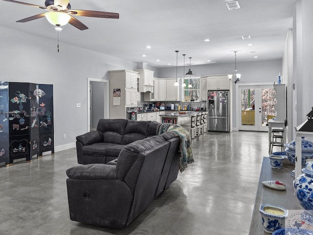 living room featuring french doors, concrete floors, and ceiling fan