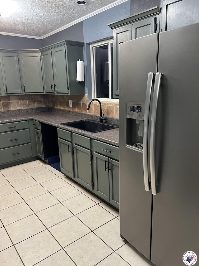 3609 Belmont Ave, Texarkana, AR 71854 - kitchen featuring stainless steel refrigerator with ice dispenser, light tile patterned flooring, dark countertops, a textured ceiling, and crown molding