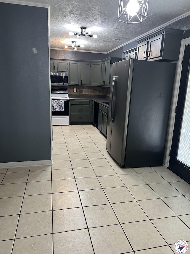 3609 Belmont Ave, Texarkana, AR 71854 - kitchen with stainless steel appliances, light tile patterned floors, crown molding, a textured ceiling, and dark countertops