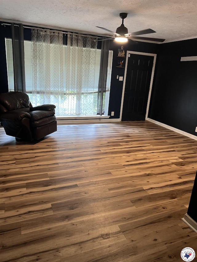 3609 Belmont Ave, Texarkana, AR 71854 - living room featuring a textured ceiling, wood finished floors, and ceiling fan