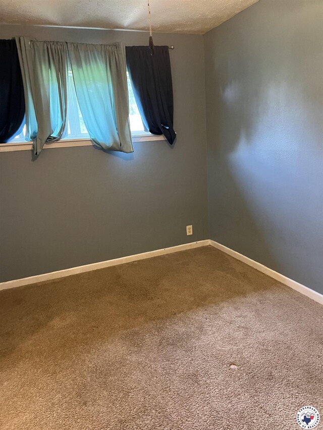 3609 Belmont Ave, Texarkana, AR 71854 - carpeted spare room featuring a textured ceiling and baseboards
