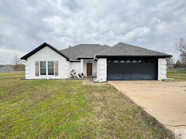 single story home featuring a front yard, an attached garage, driveway, and a shingled roof