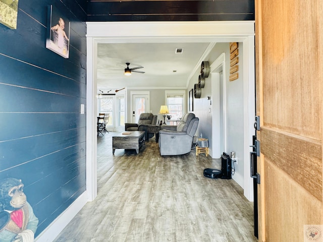 interior space featuring crown molding, wood finished floors, and visible vents