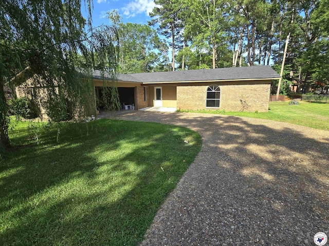 1405 S Fulton St, Hope, AR 71801 - back of house with a yard, brick siding, and driveway