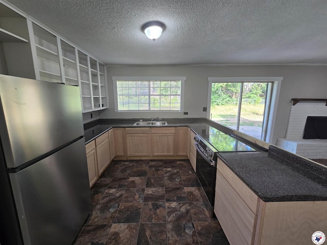 1405 S Fulton St, Hope, AR 71801 - kitchen with freestanding refrigerator, light brown cabinets, black range with electric cooktop, open shelves, and a sink