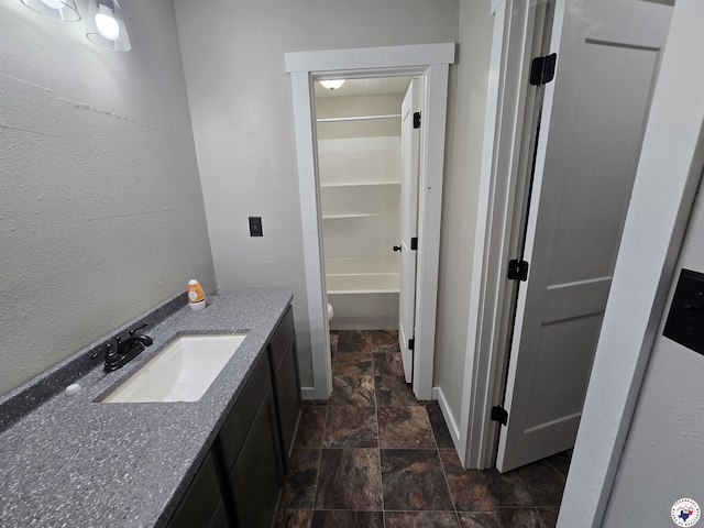1405 S Fulton St, Hope, AR 71801 - full bath with stone tile floors, vanity, toilet, a tub, and baseboards