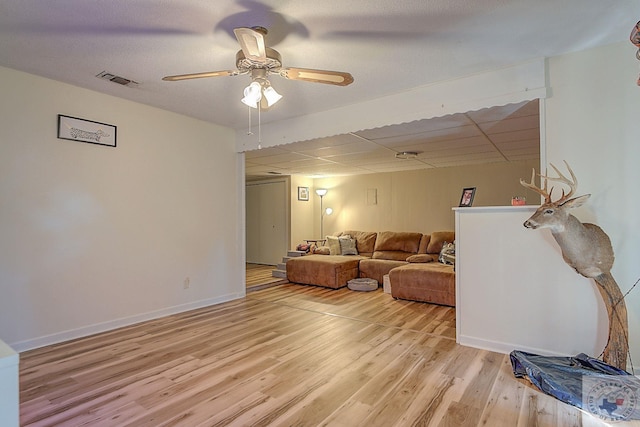 living room featuring ceiling fan and light hardwood / wood-style flooring