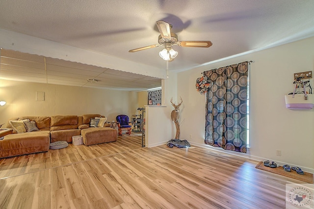 living room featuring ceiling fan and light wood-type flooring