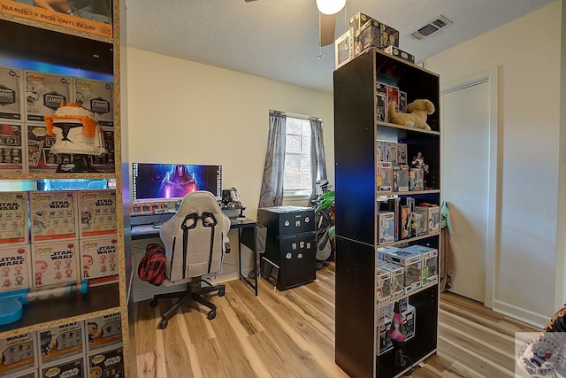 office space with ceiling fan, a textured ceiling, and wood-type flooring